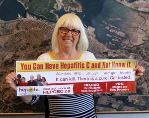 Hepatitis C information on a bus ad, held by Nanaimo City Councilor